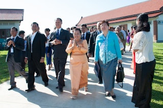 Representative of the Universal House of Justice, Ms. Sokuntheary Reth (center), walks with government representatives and representatives of the Baha'i community. Representative of the Universal House of Justice, Ms. Sokuntheary Reth (center), walks with government representatives and representatives of the Baha'i community.
