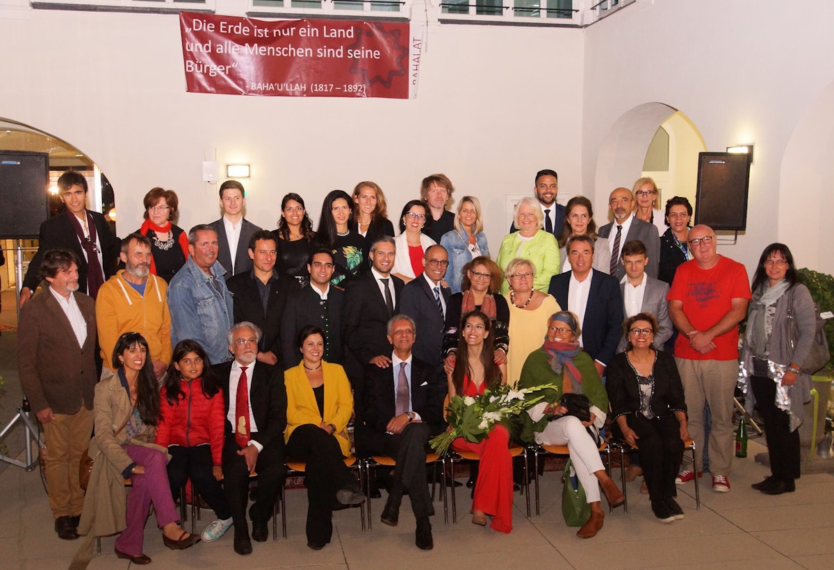 Mayor Richard Hemmer (second row, fourth from the right) and members of the city council, together with some of the volunteers at the celebration to commemorate the bicentenary of the birth of Baha'u'llah in Bruck, Austria, last week