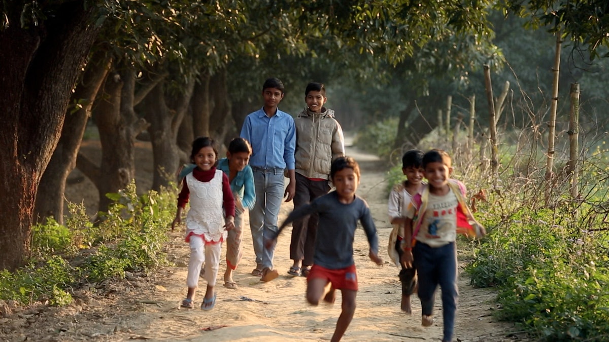 A screenshot from “Light to the World” shows a group of young people engaged in community-building activities.