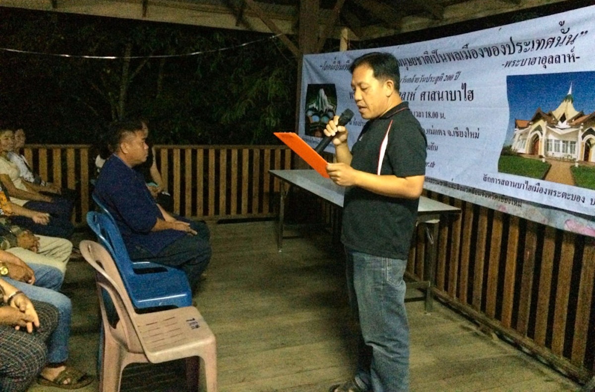 A village leader near Chiang Mai reads the message of the Prime Minister of Thailand addressed to the Baha'i community.