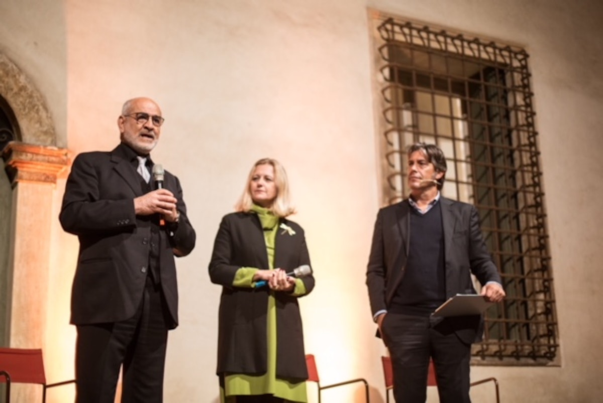 Sohrab Youssefian (left) speaks at the opening of the exhibition.