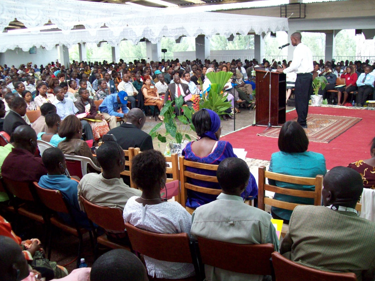 A young man addresses the Baha’is gathered in Nakuru, a city of 300,000 people northwest of Nairobi, Kenya.