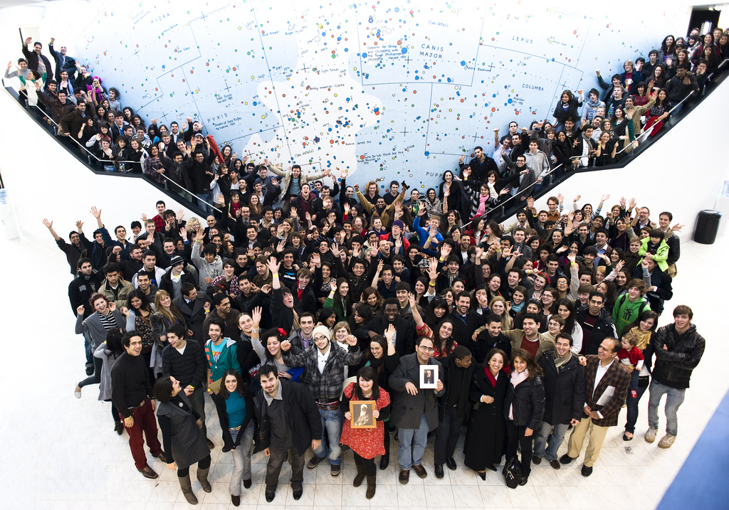 More than 340 young people at the conference in England pose in front of a fantasy map outside the venue at the University of Warwick. The gathering was planned in large measure by the youth themselves. (Photograph by Ronnie Yousefzadeh-Bindra)