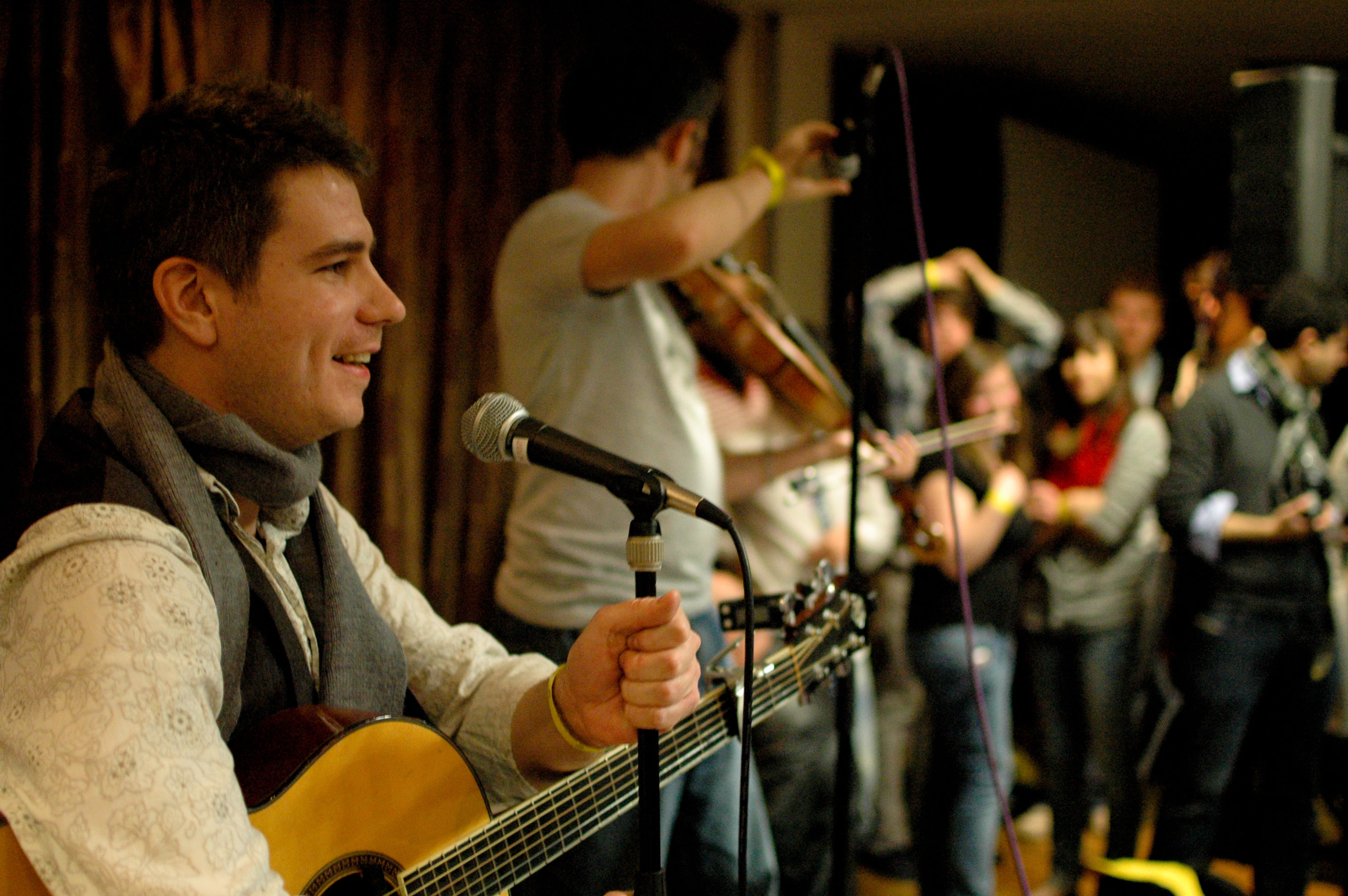 Simon T. Munro and other musicians perform at a session of the youth conference in England.