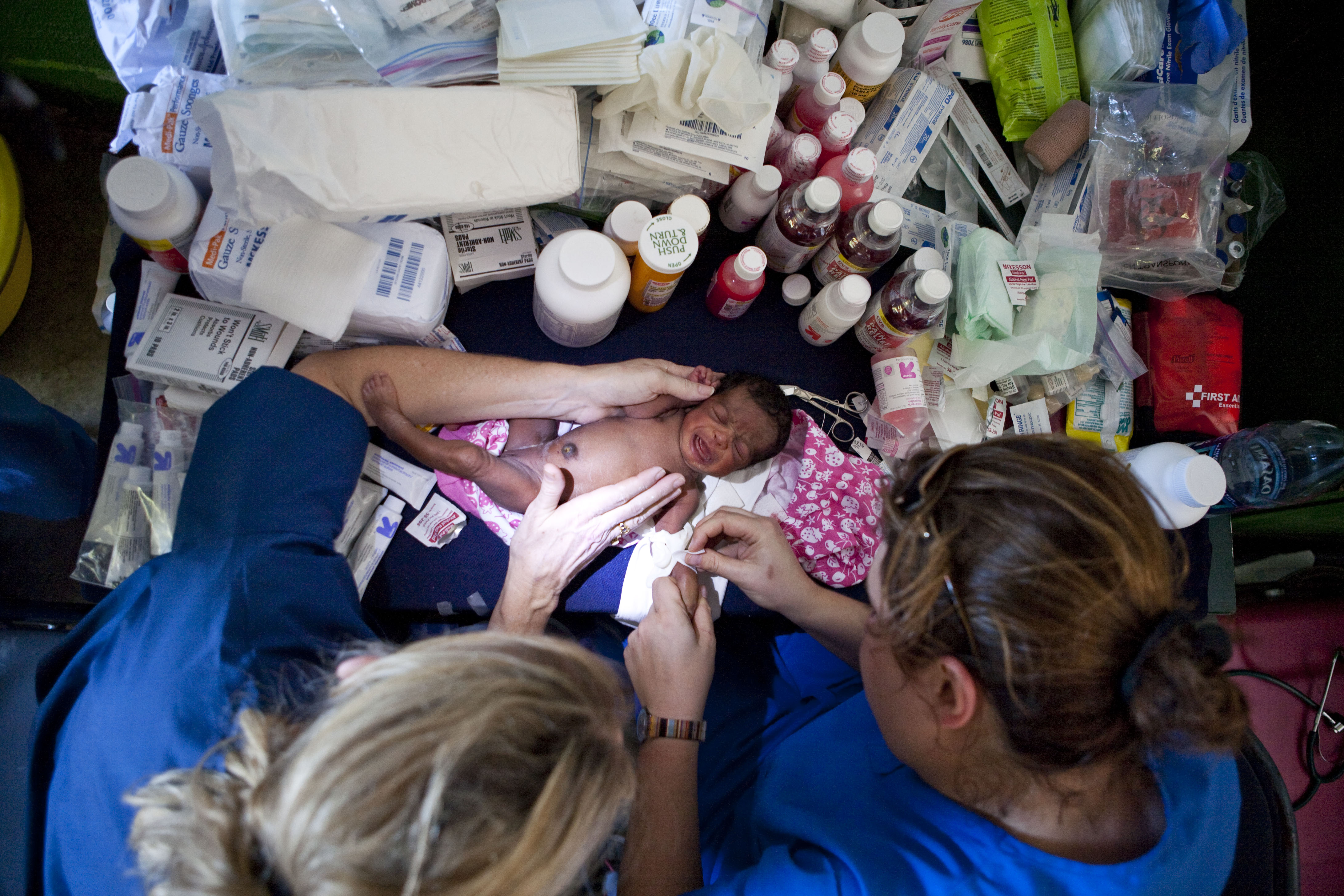 A dehydrated baby, only a few days old, is examined by pediatrician Munirih Tahzib and Maryanne Fike, both of New Jersey. The infant and her mother were suffering from life-threatening infection and were rushed to a hospital for treatment.