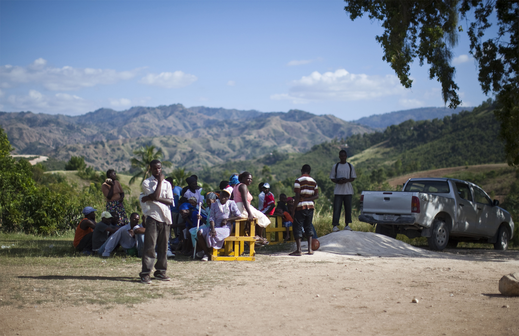 People rest in the shade of a tree as they wait their turn for a medical examination by volunteer doctors from the United States and Canada. The visitors were only able to stay for a week but hope to return periodically to provide ongoing assistance.