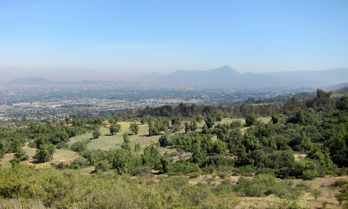 A view of the site of the future Baha'i House of Worship for Chile. Suburbs of the city of Santiago can be seen in the valley below.