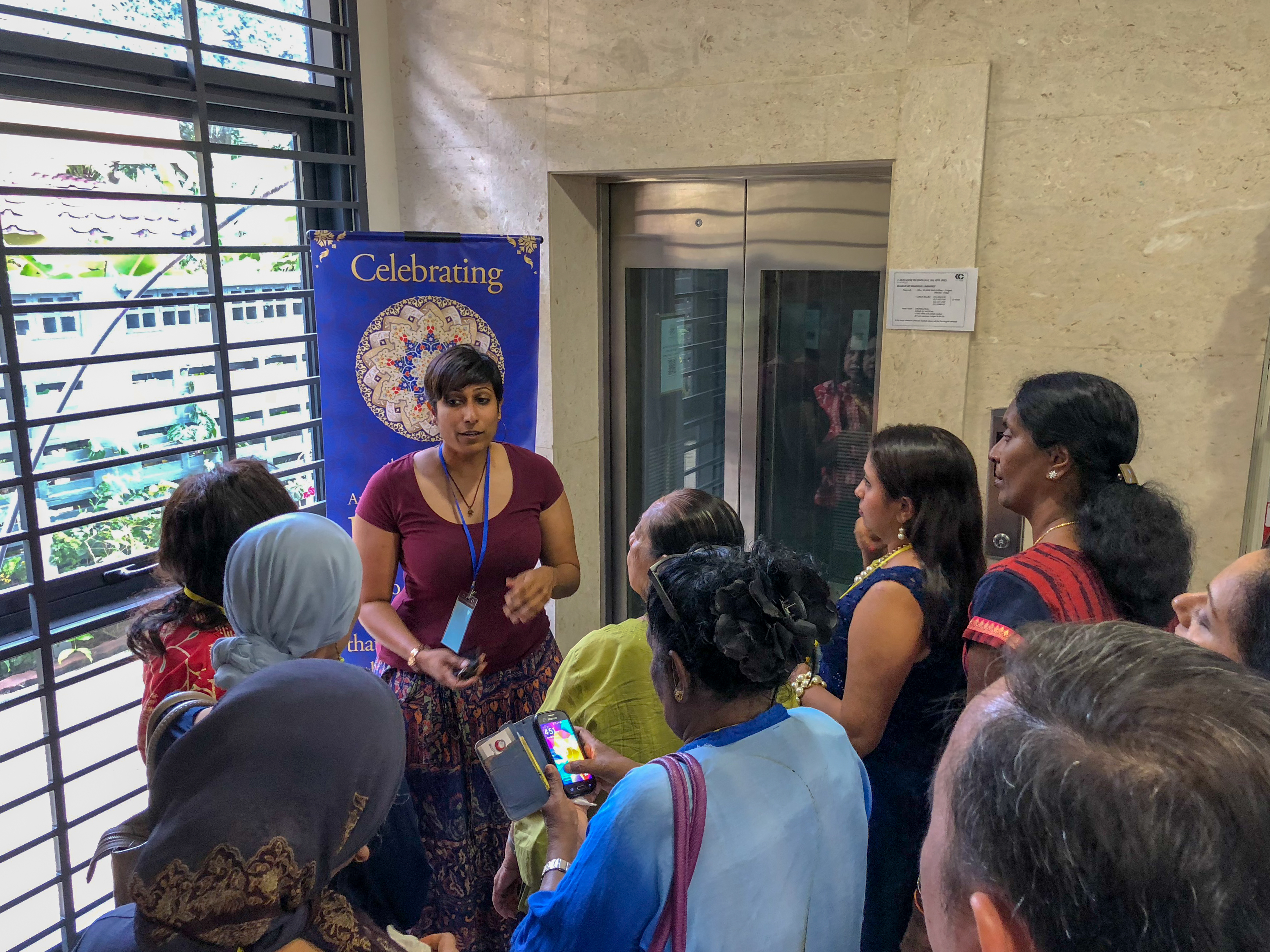 An usher briefs a group of guests before they begin their journey through the exhibition.