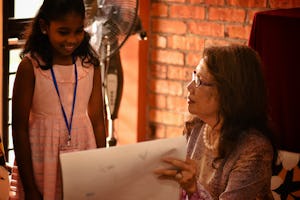 In Malaysia, the Baha’i community’s national commemoration marking the bicentenary of the birth of Baha’u’llah welcomed guests of all ages and diverse backgrounds for a creative exploration of the life and teachings of Baha’u’llah. In zone 11 of the exhibition, children shared their class work from Baha’i children’s classes with guests. Here, Dato’ Halimah Mohd Said—President of the Association of Voices of Peace, Conscience and Reason—discusses an art piece with one of the child presenters.