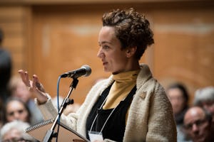 An audience member addresses the speakers at a panel discussion.