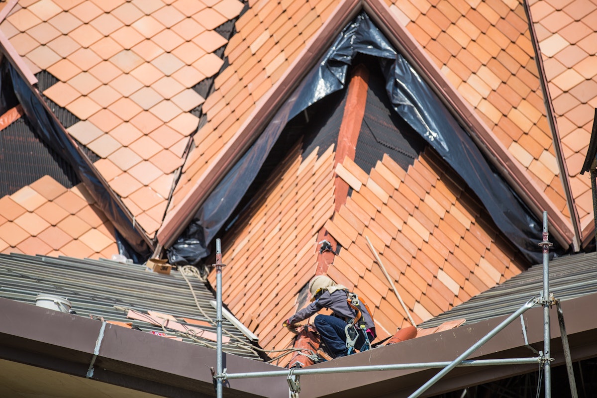 Terracotta tiles being placed on the roof of the local House of Worship in Norte del Cauca