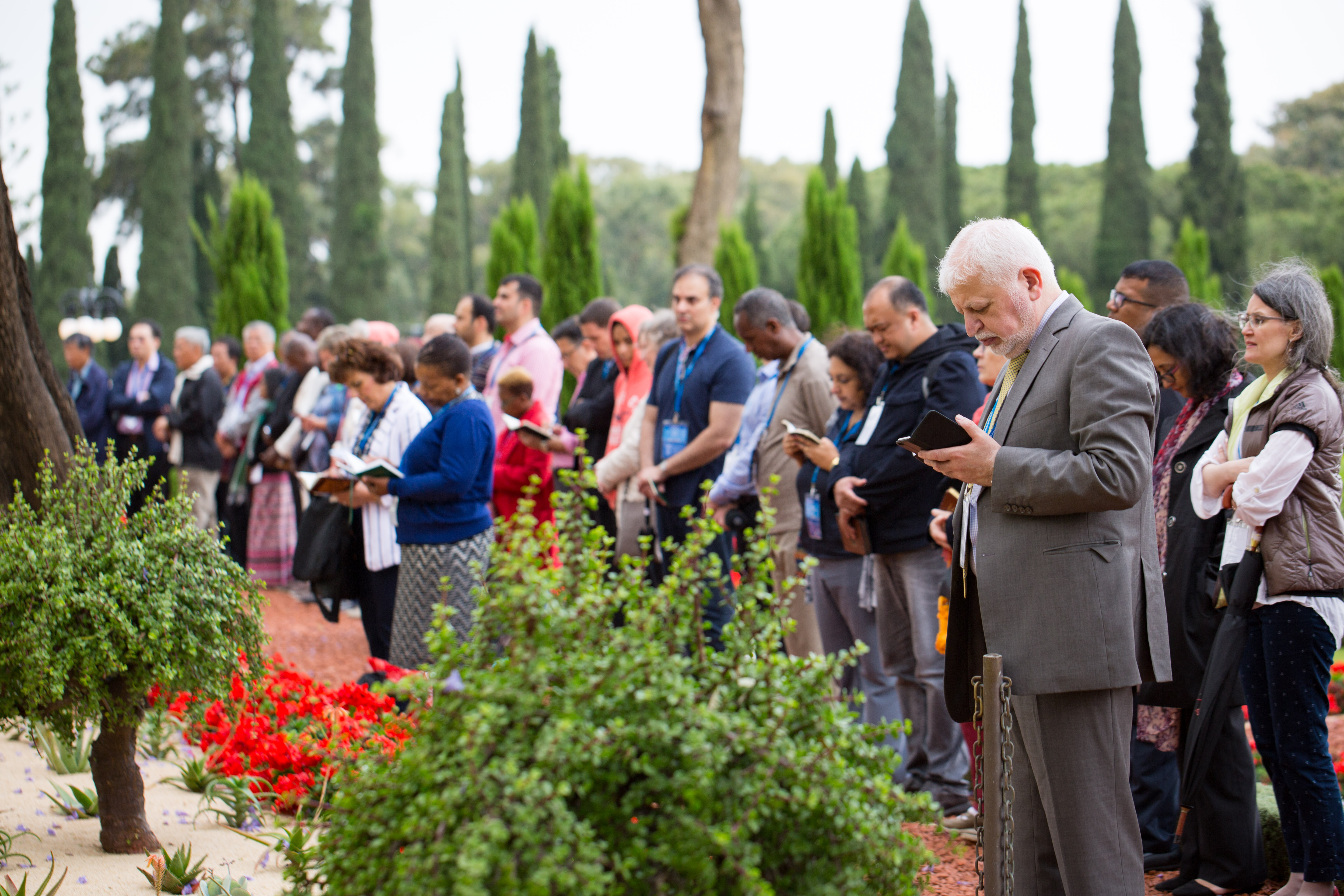 Delegates pray in the gardens surrounding the Shrine of Baha’u’llah in Bahji.