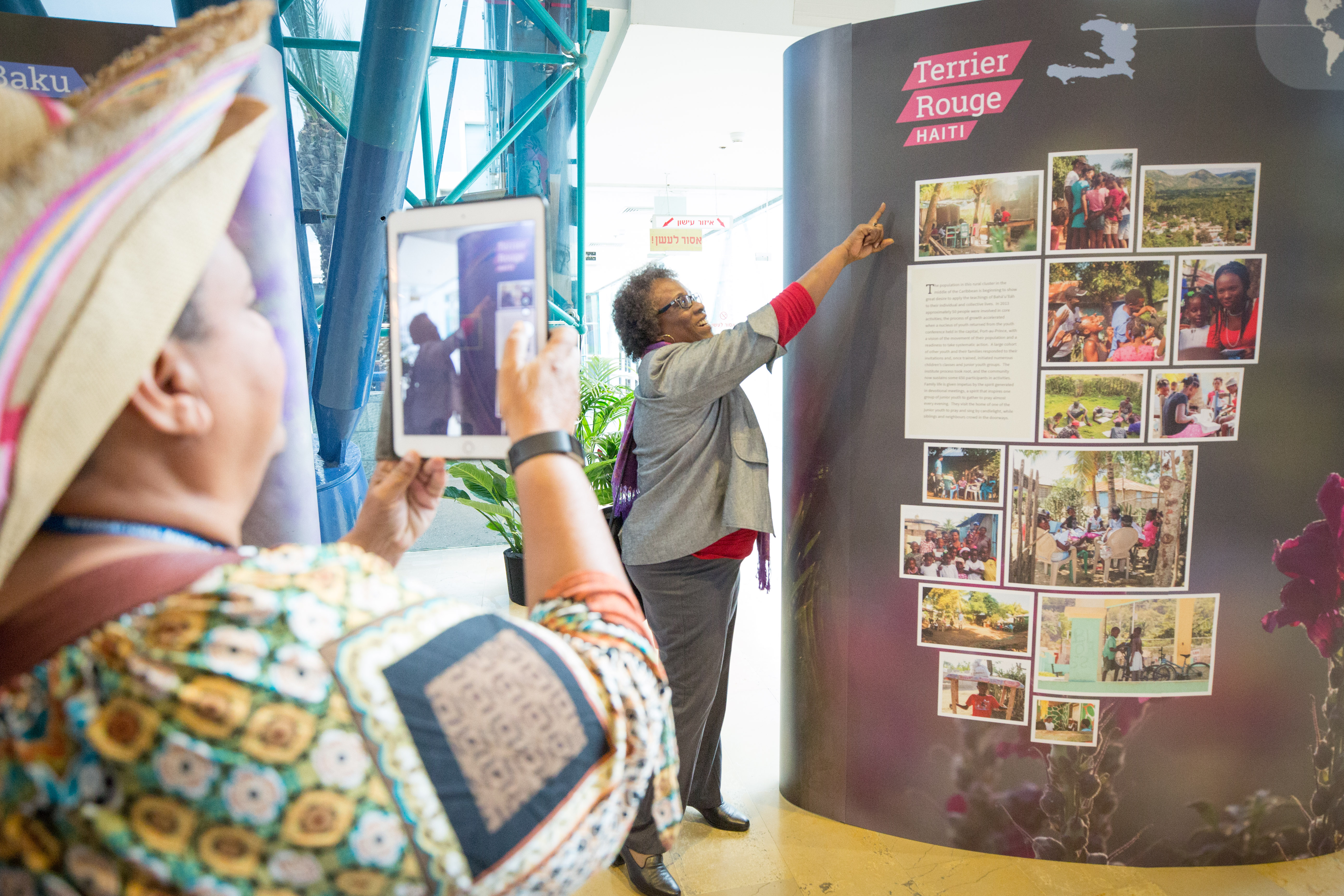 An exhibition of photos from around the world is on display at the Haifa International Convention Centre. A delegate looks at photos from Haiti.
