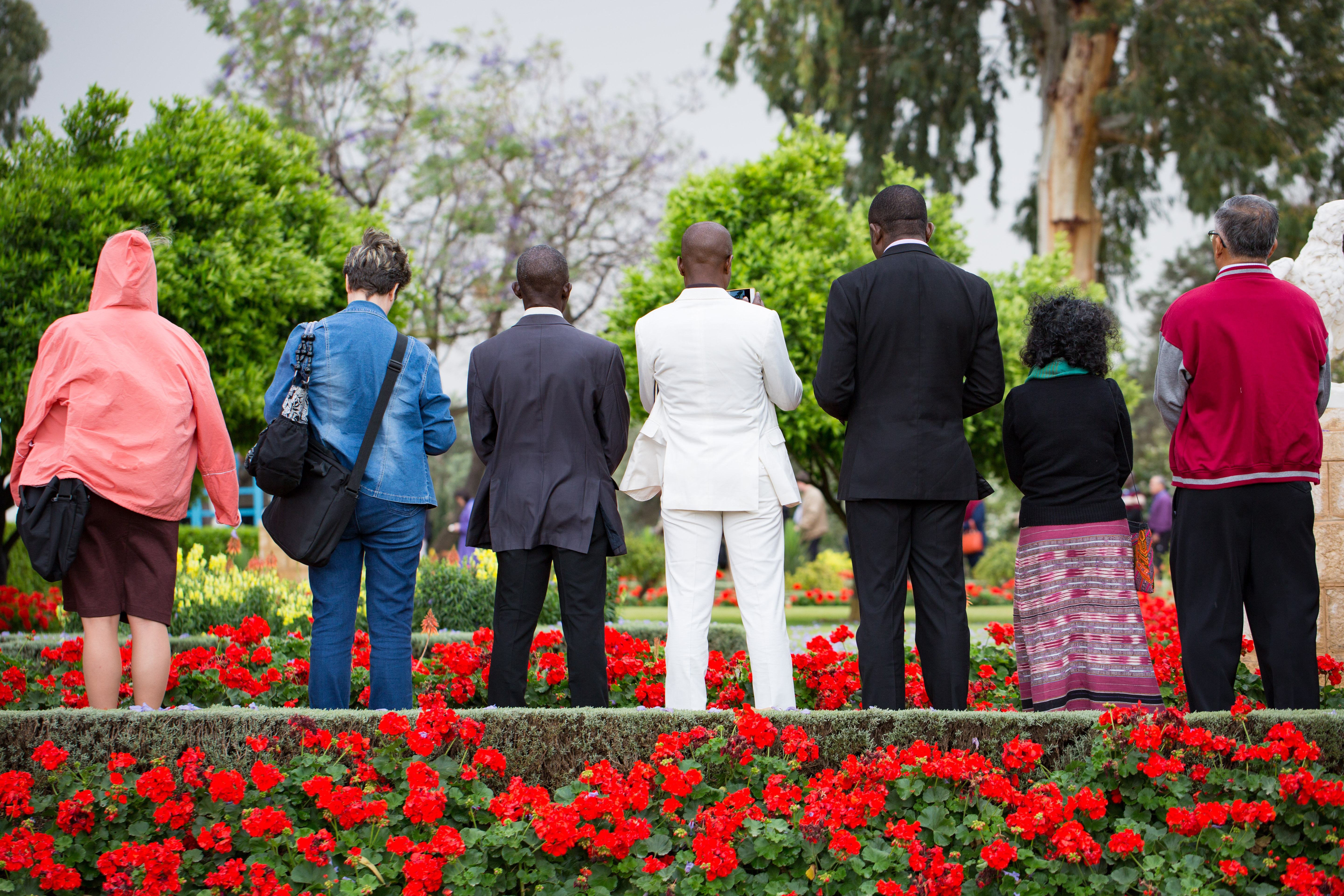 Delegates offer prayers in the gardens surrounding the Shrine of Baha’u’llah.
