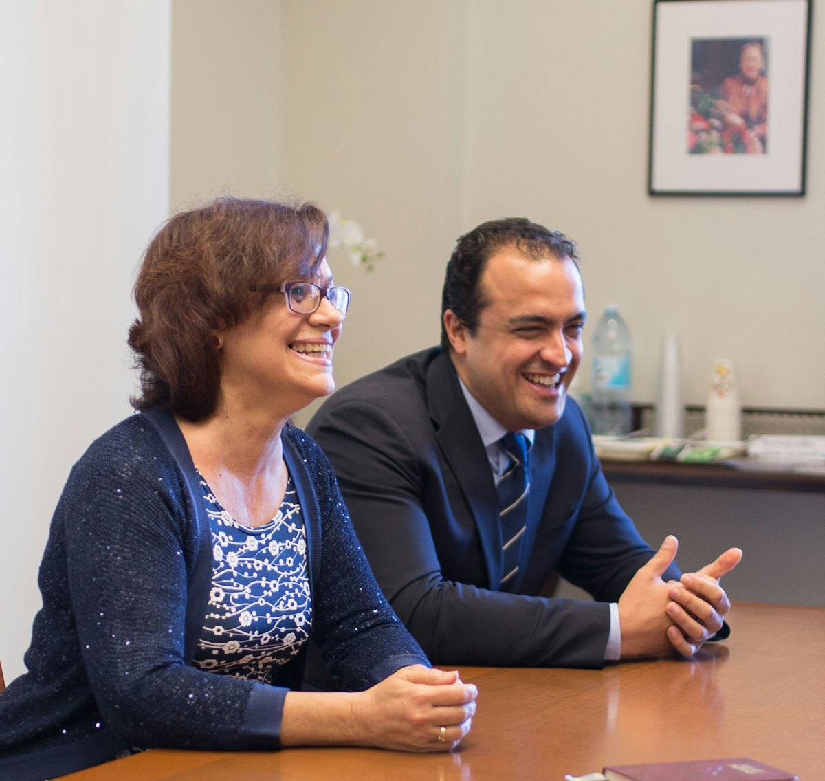 Zoraida Garcia Garro (left) and Saba Mazza, members of the Continental Board of Counsellors in Europe, laugh during their conversation with fellow Counsellors.