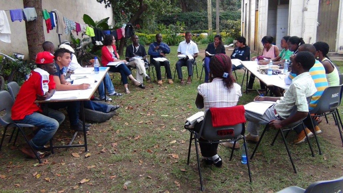 A group of university students at the seminar in Kenya consults.