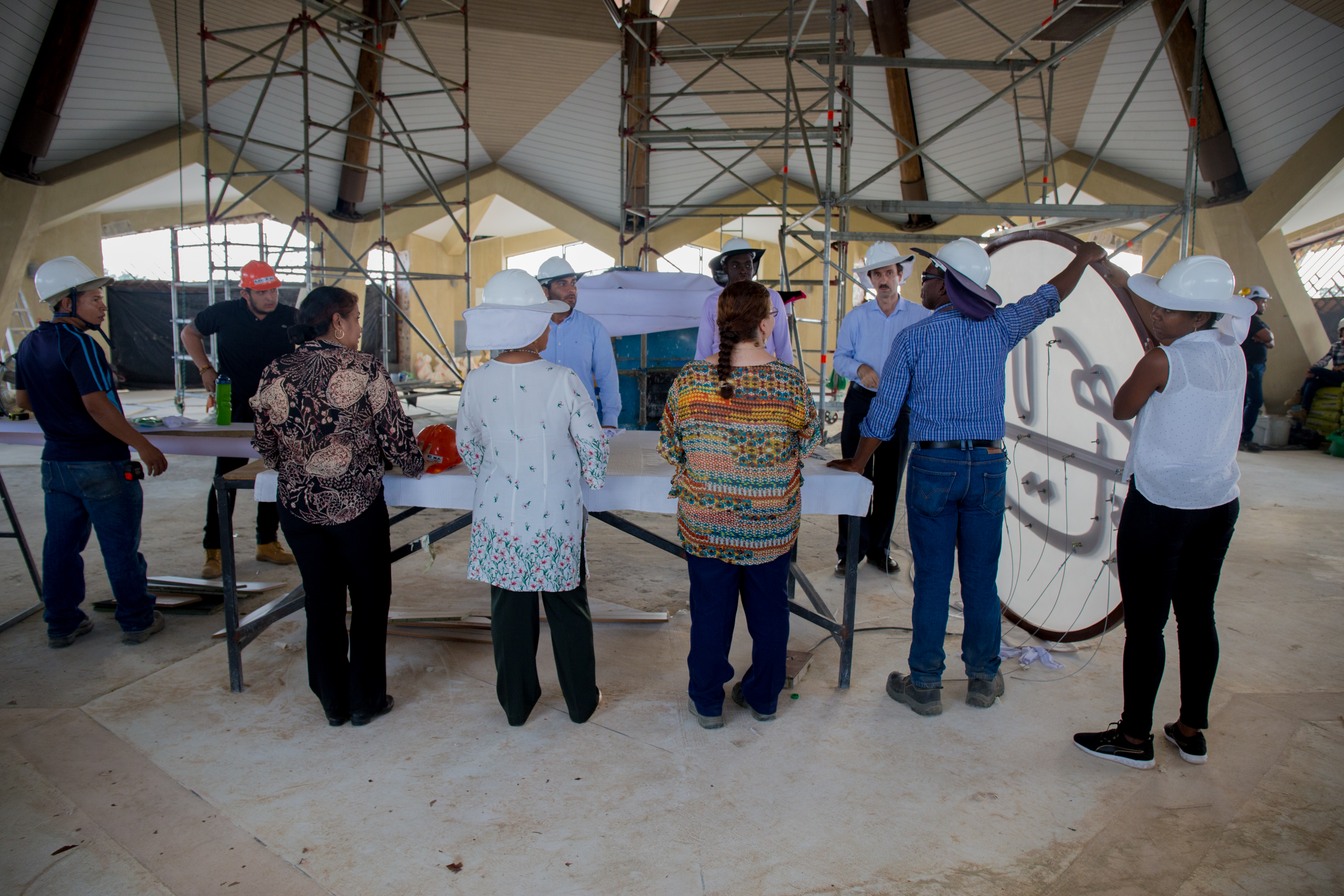 Some members of the team present for the raising of the Greatest Name look on as final preparations are made.
