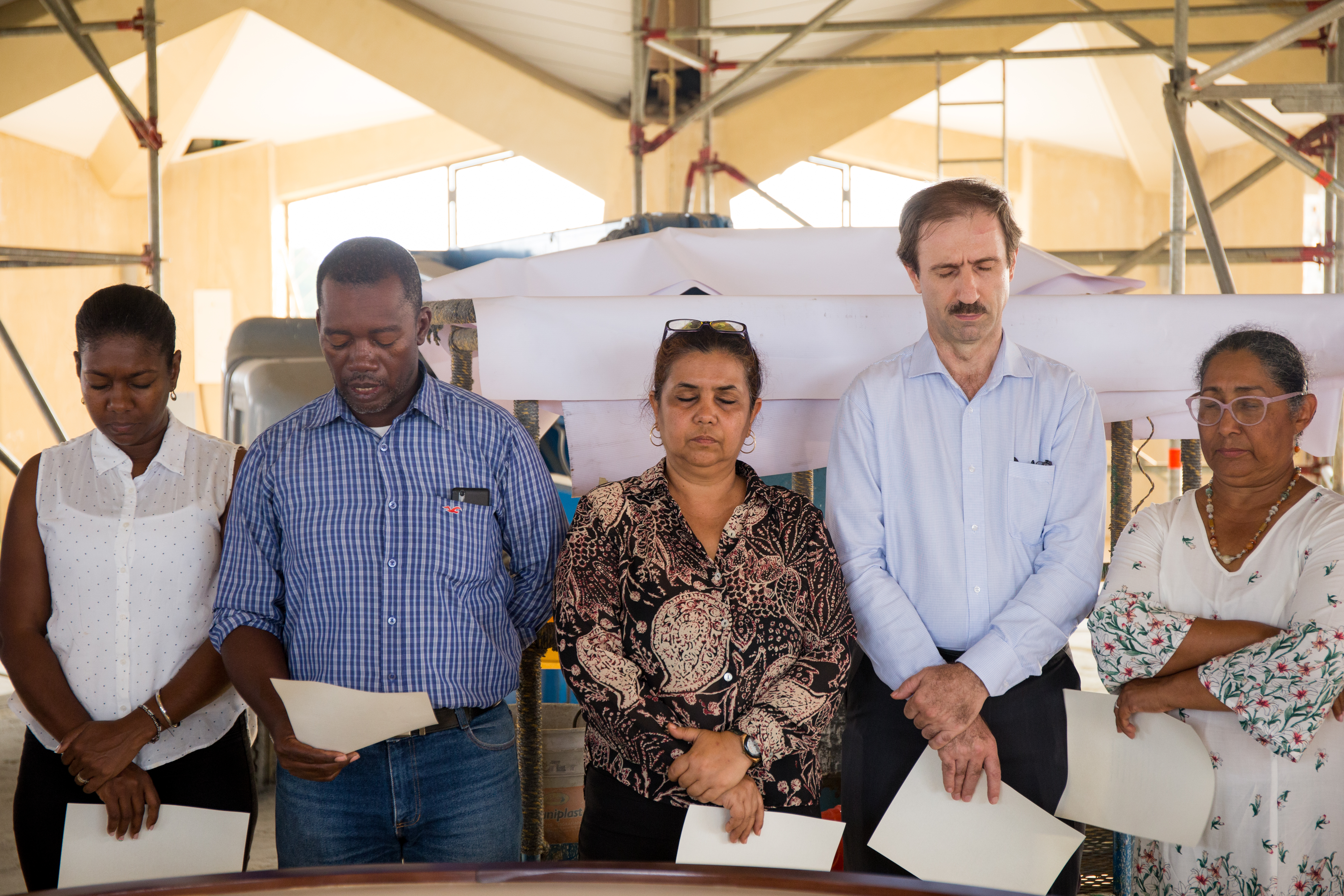 Representatives of the Baha’i community of Colombia say prayers before raising the Greatest Name to the apex of the Temple.
