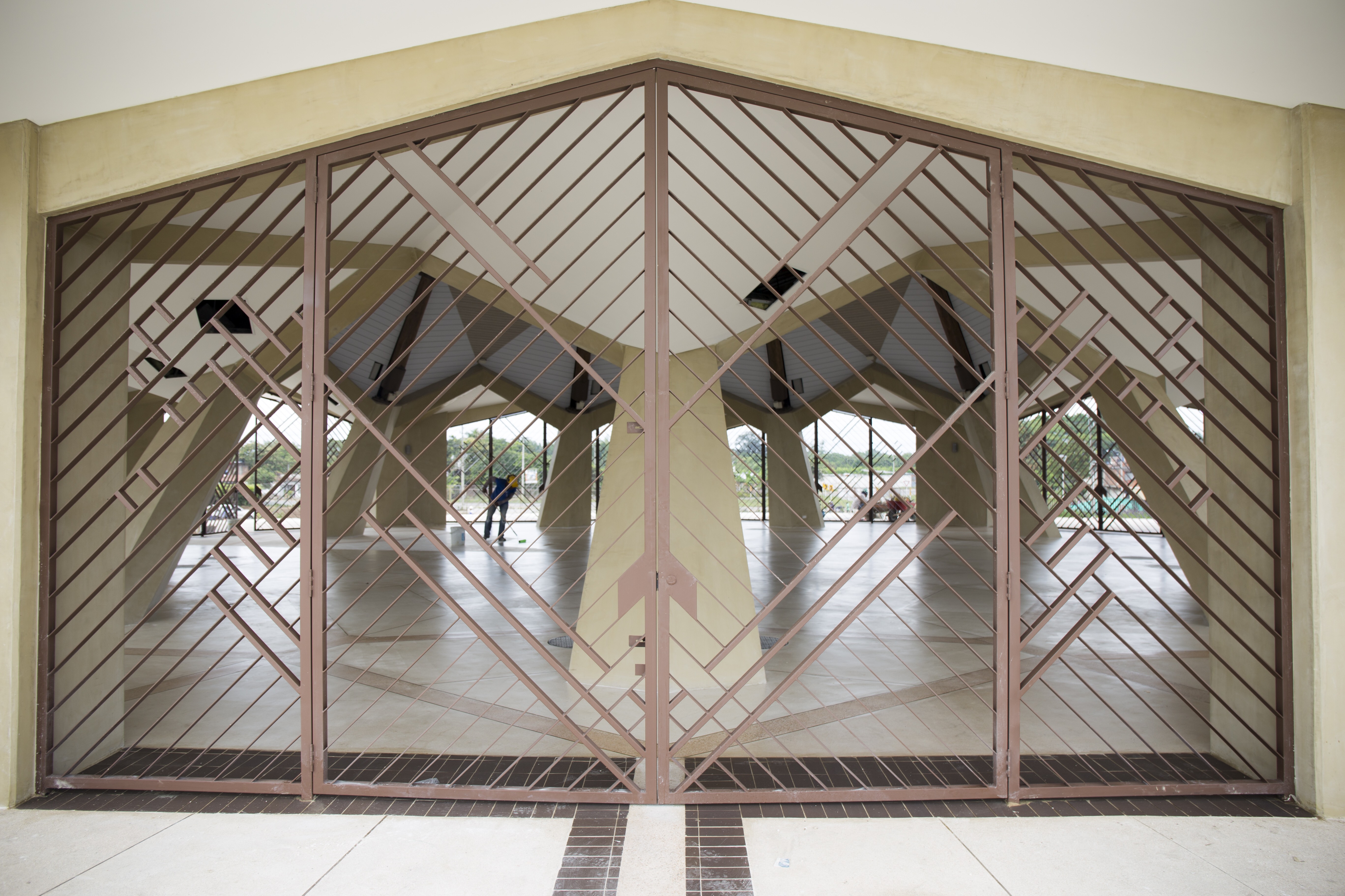 The open nature of the structure allows air to flow through and cool the interior of the central edifice. A worker cleans the floor in preparation for Sunday's inauguration ceremony.