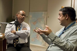 Taraz Nadarajah (right), a member of the Continental Board of Counsellors in Australasia, speaks with Mark Sisson, a member of the Board of Counsellors in the Americas.