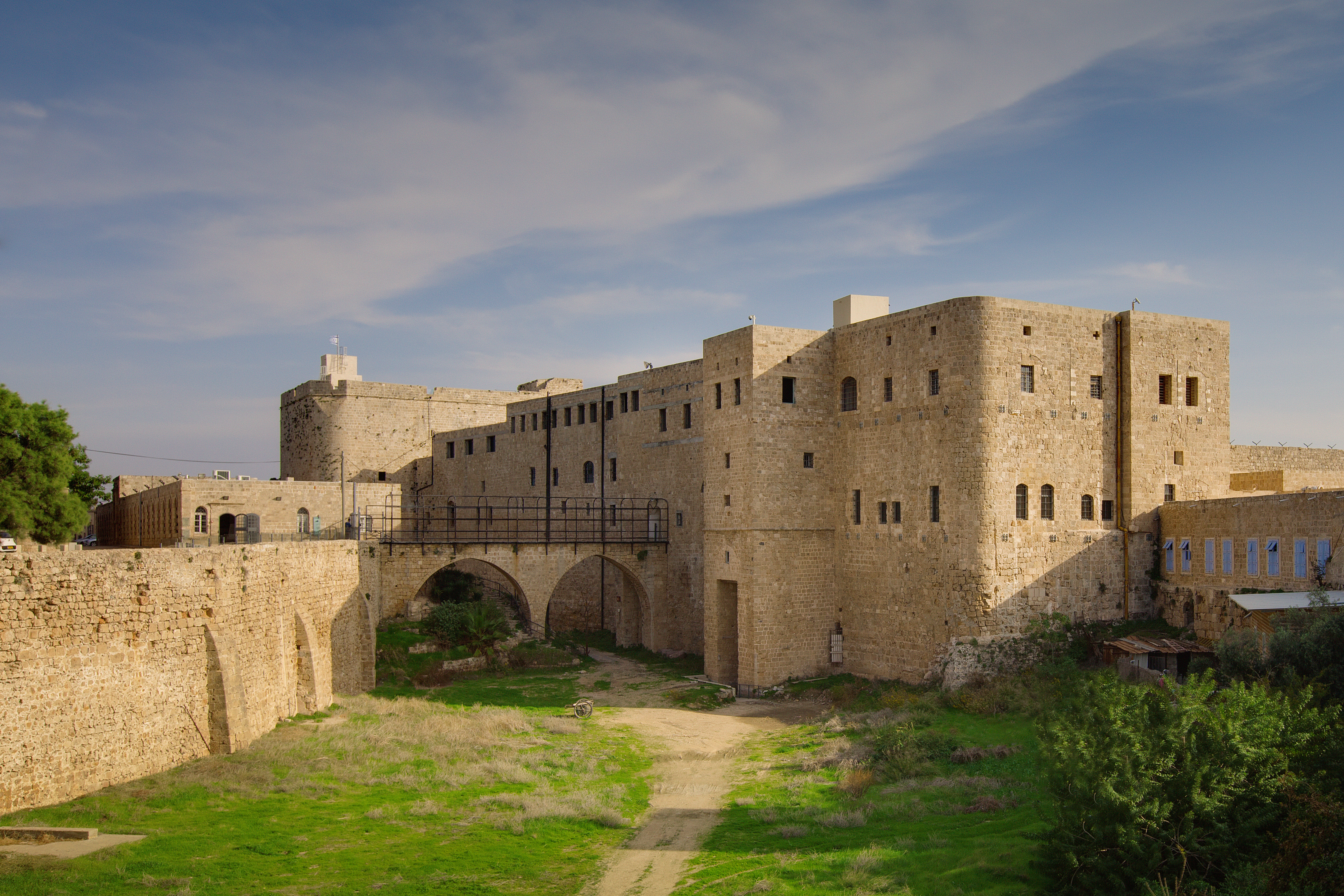 The prison where Bahá’u’lláh spent two years, two months, and five days was a military barracks. In this recent photo, the two windows farthest to the right of the top level show the room that Bahá’u’lláh occupied.