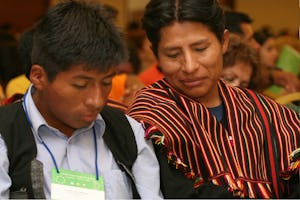 Two of the 600 participants at the Baha’i conference in Antofagasta, Chile, on 29-30 November are shown at a plenary session.