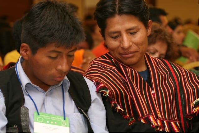 Two of the 600 participants at the Baha’i conference in Antofagasta, Chile, on 29-30 November are shown at a plenary session.