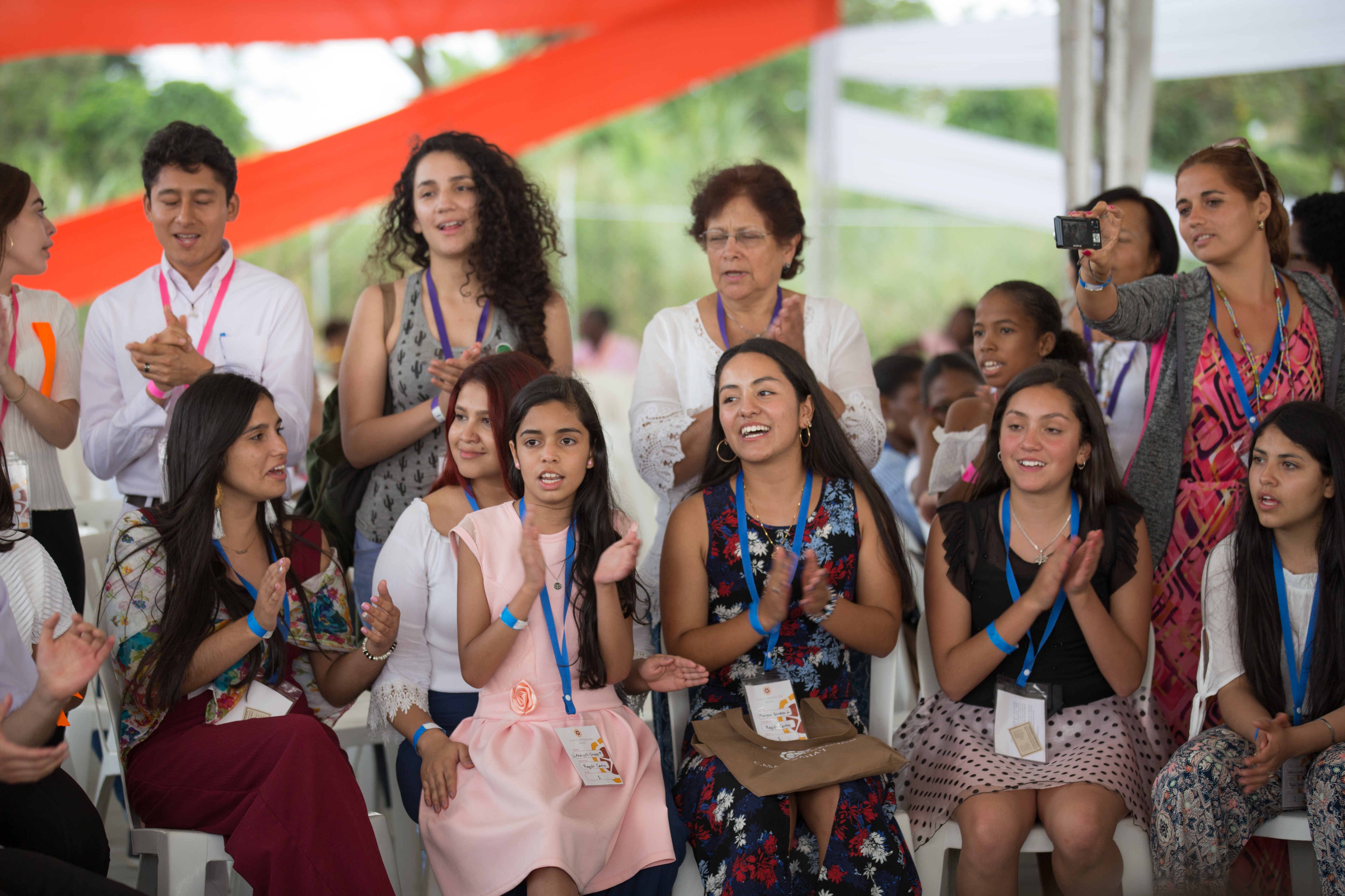 A group of youth joined together in collective singing.