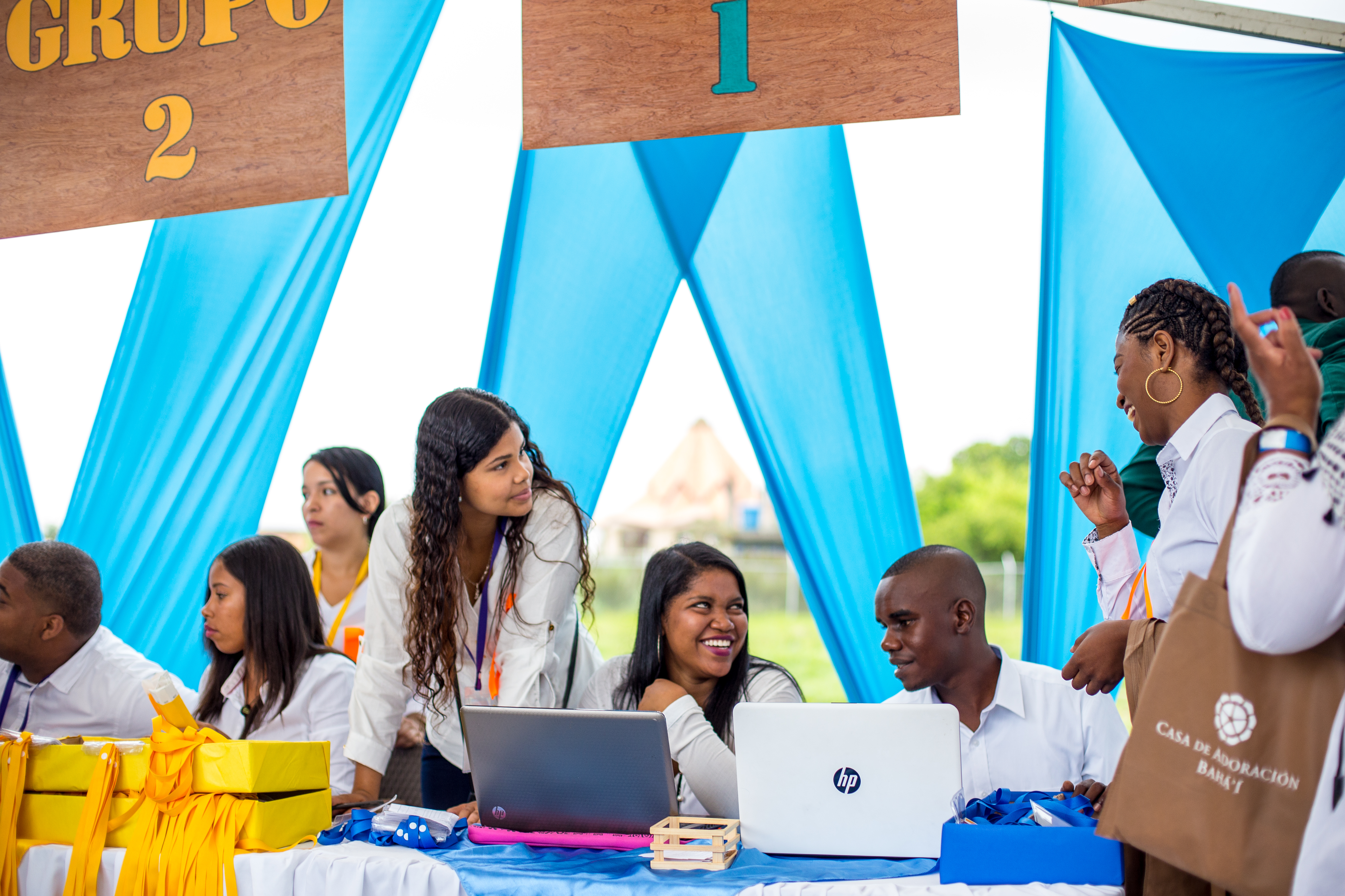 Volunteers joyfully welcome and register participants in the Temple’s dedication ceremony.