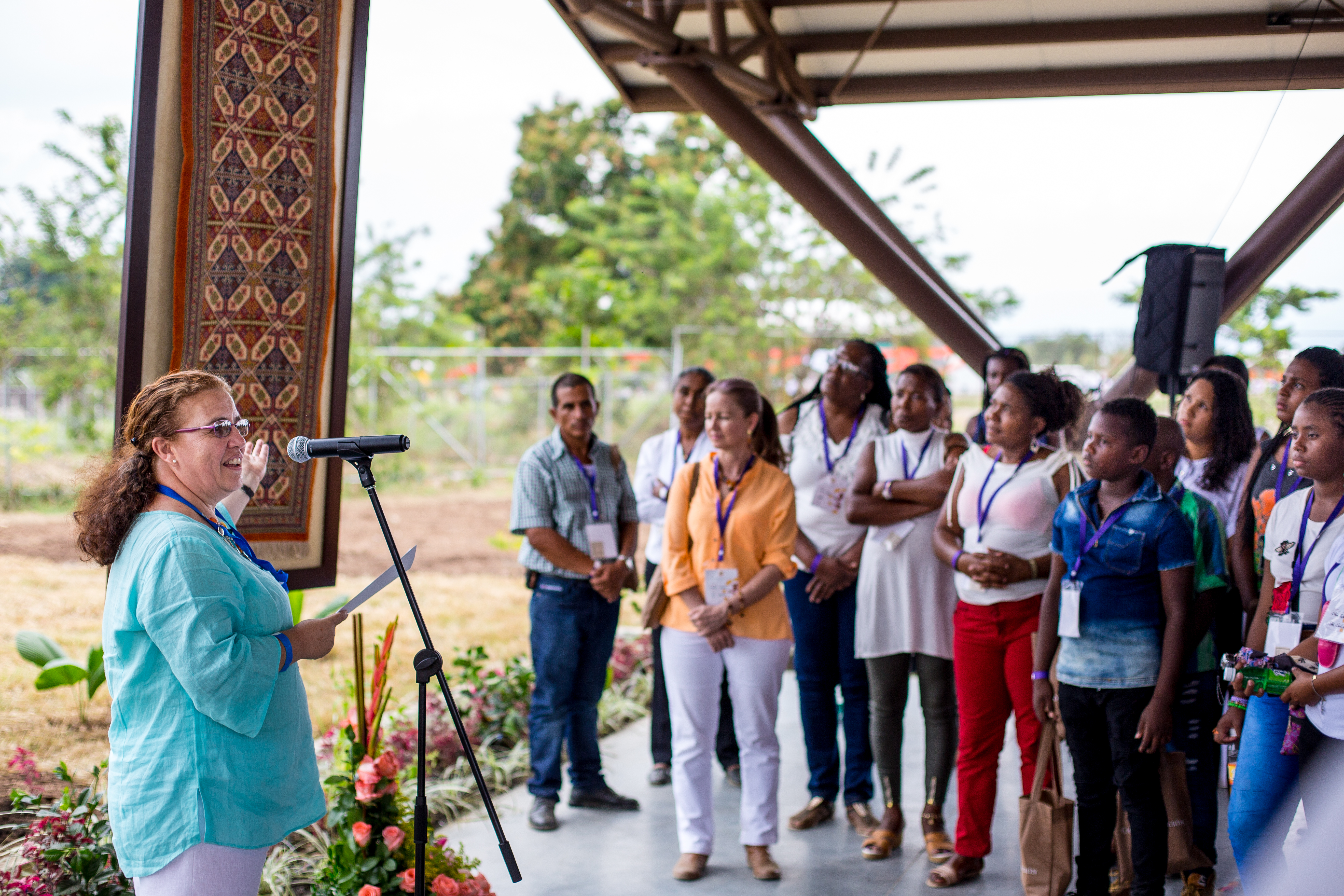 People look at a special carpet that had been placed in the Shrine of the Bab and was delivered for the House of Worship, signifying the Temple’s profound connection with the spiritual center of the Baha’i Faith.