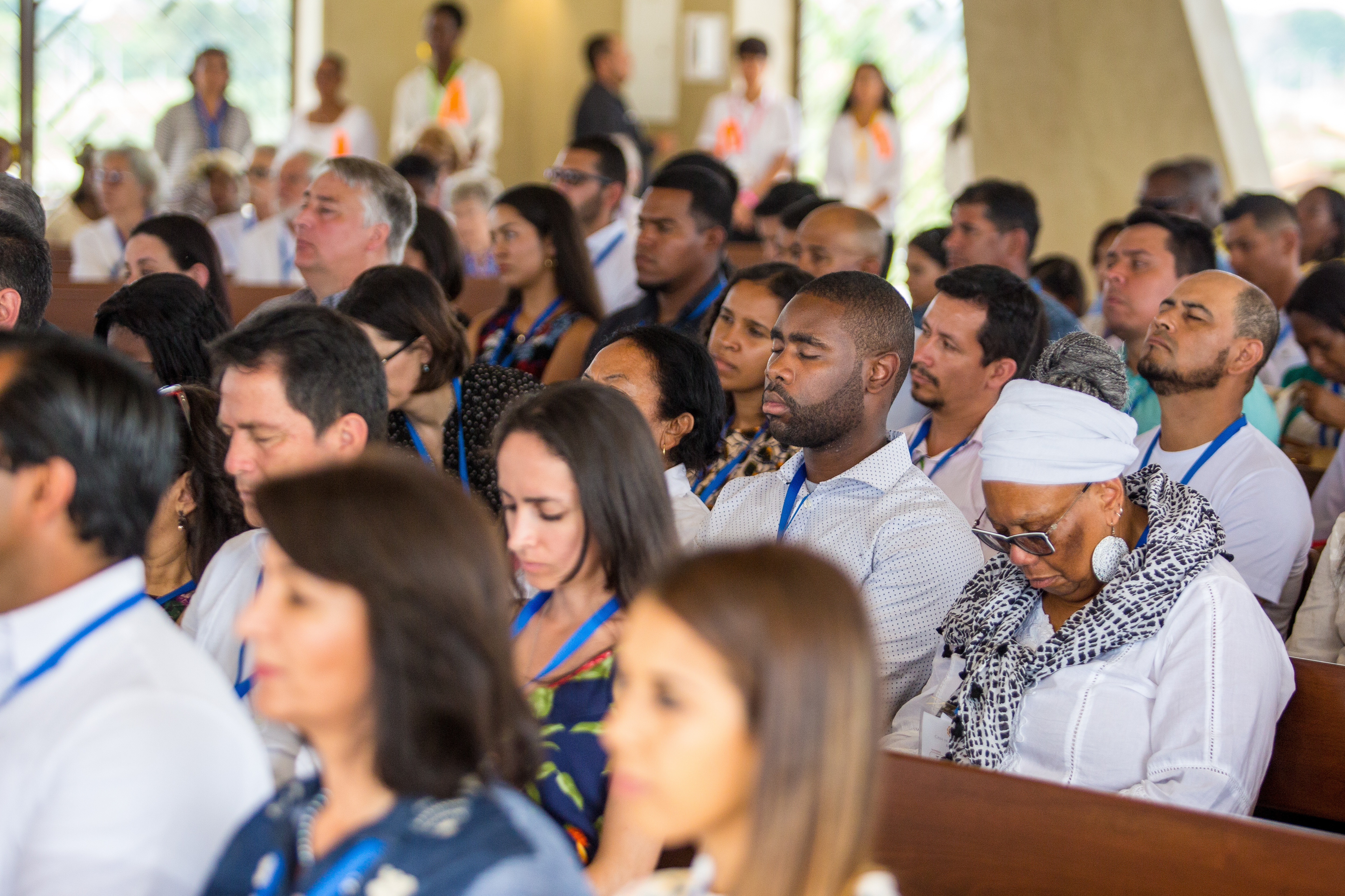 People reverently listen to prayers in the Temple.