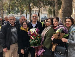Afif Naeimi (center) stands with loved ones in Tehran earlier today after completing his unjust 10-year prison sentence.
