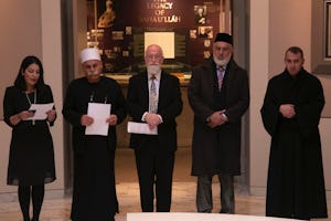 (From left) Carmel Irandoust, deputy secretary-general of the Baha’i International Community, reads a prayer as Sheikh Jaber Mansour, Rabbi David Metzger, Emir Muhammad Sharif Odeh, and Father Yousef Yakoub listen.