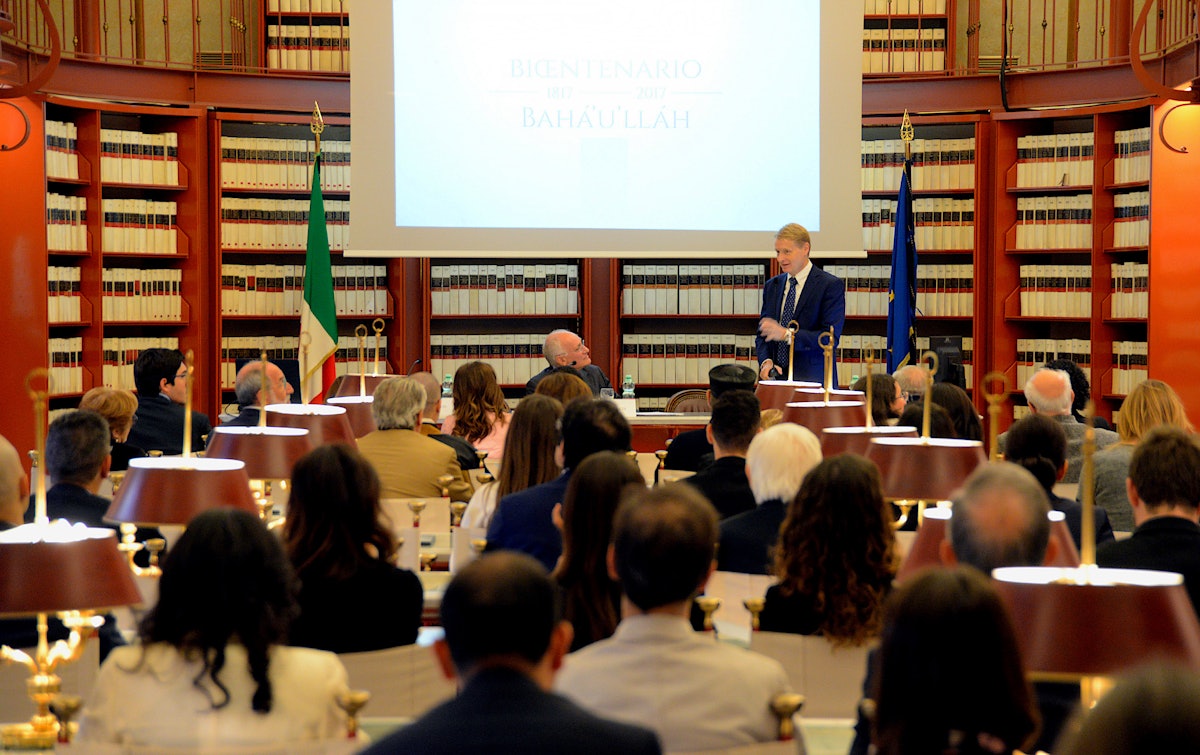 Italian Senator Lucio Malan speaks during a celebration of the bicentenary of Baha’u’llah’s birth, held in the Italian Parliament in October 2017. Lawmakers, religious leaders, and civil servants met in the Parliament’s Sala del Refettorio, where records and laws of the Italian legislature are kept and special events are occasionally held.