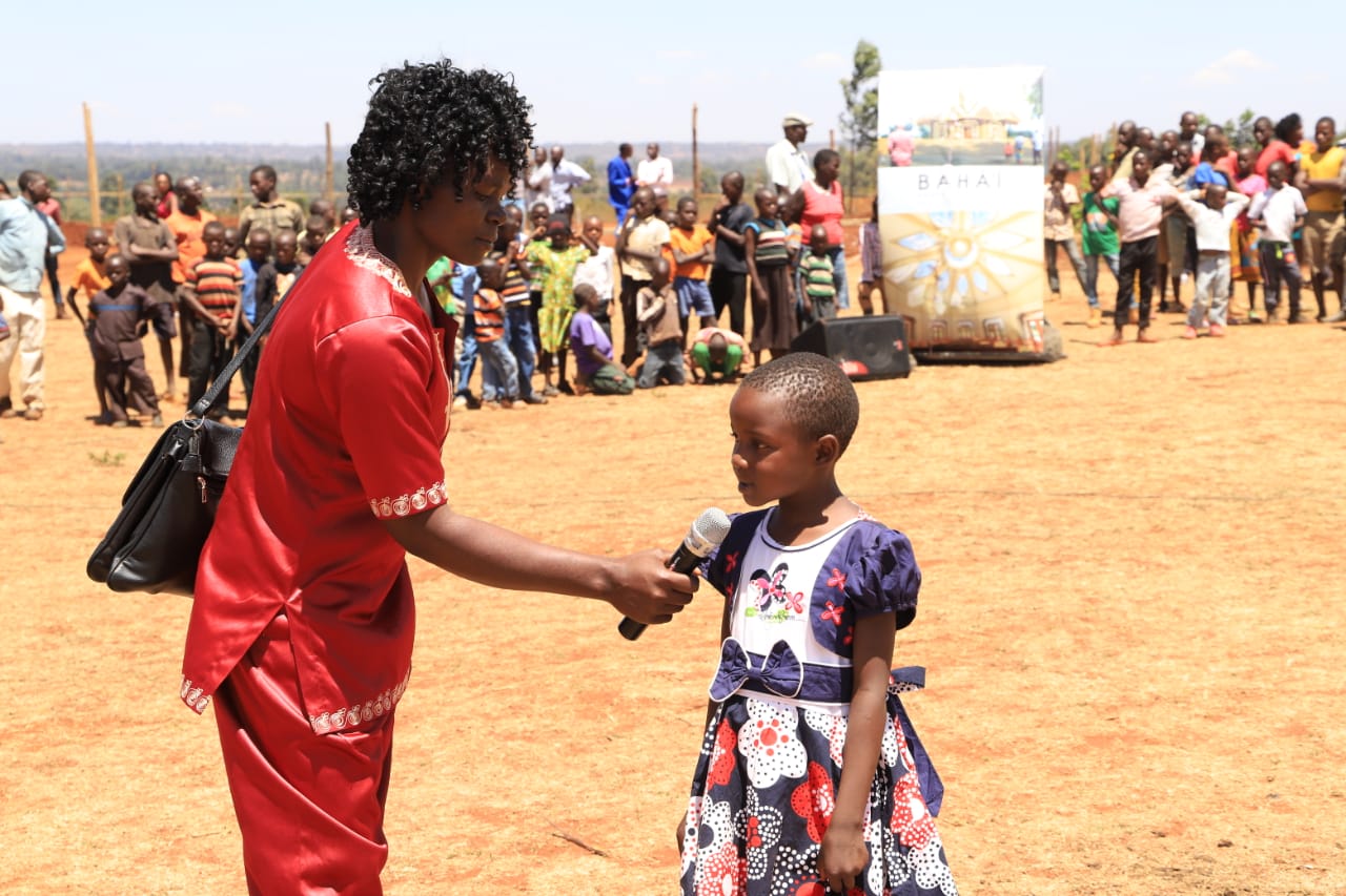 A girl recites a prayer during the groundbreaking celebration of the local Baha’i House of Worship in Matunda Soy, Kenya.