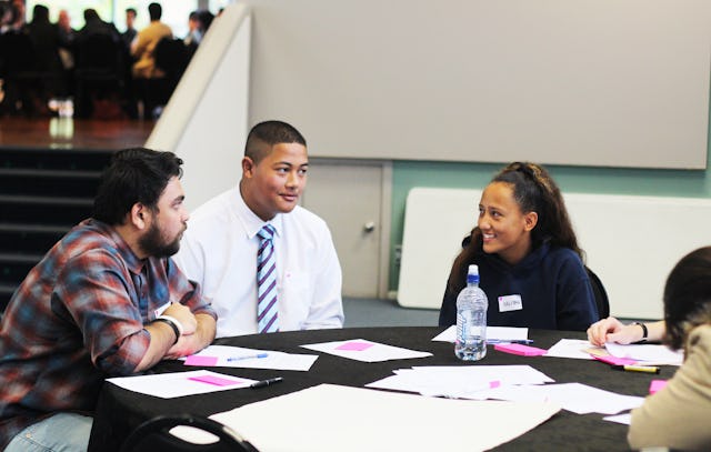 The New Zealand Baha’i community co-organizes a conference for youth alongside its annual Race Unity Speech Awards. Here, participants in last year’s conference consult during a small group session. (Credit: Tom Mackintosh)
