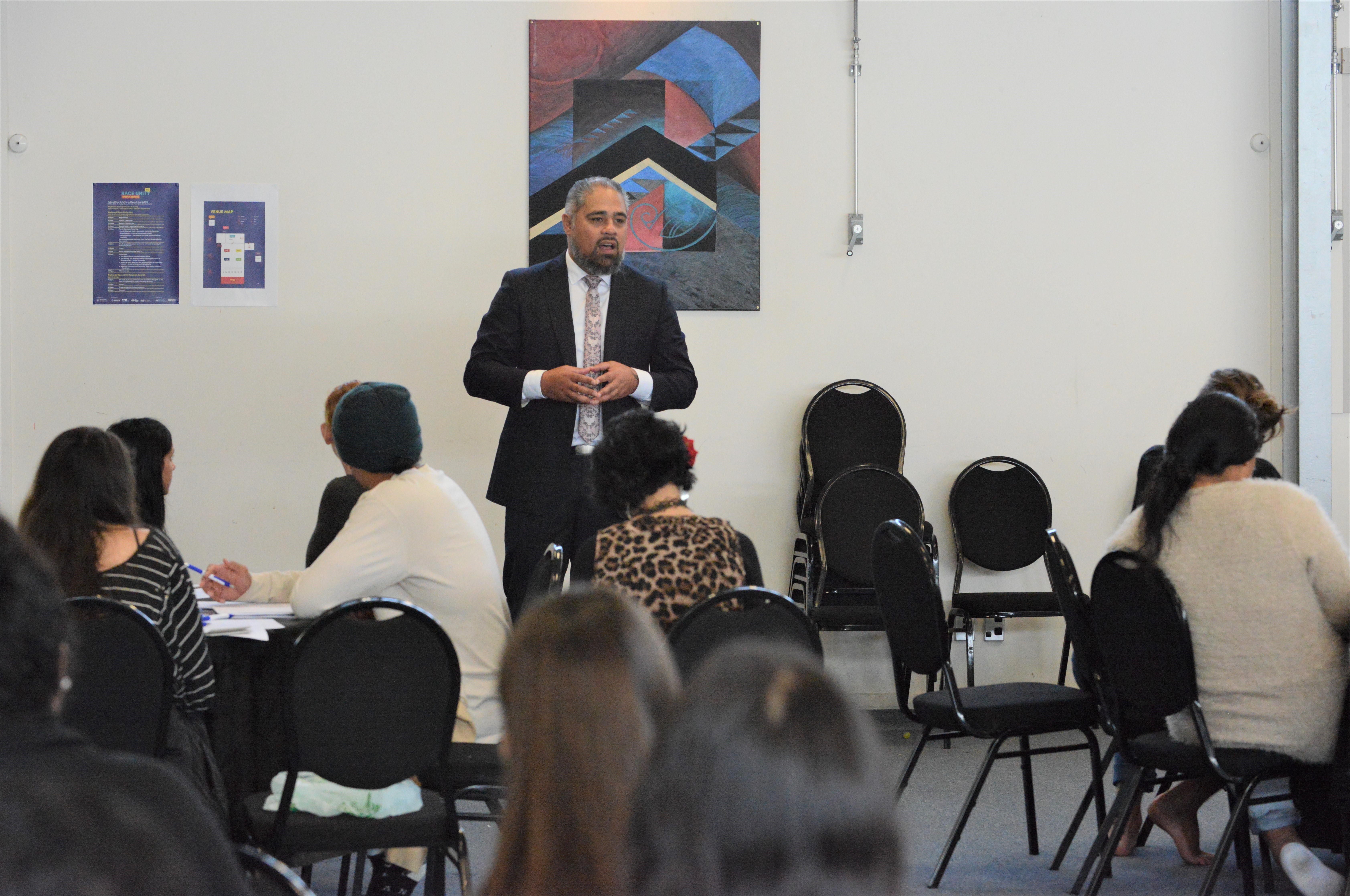 Minister for Youth Peeni Henare speaks with participants of the conference. He was one of eight Members of Parliament who attended portions of the conference and speeches. (Credit: Ben Parkinson)