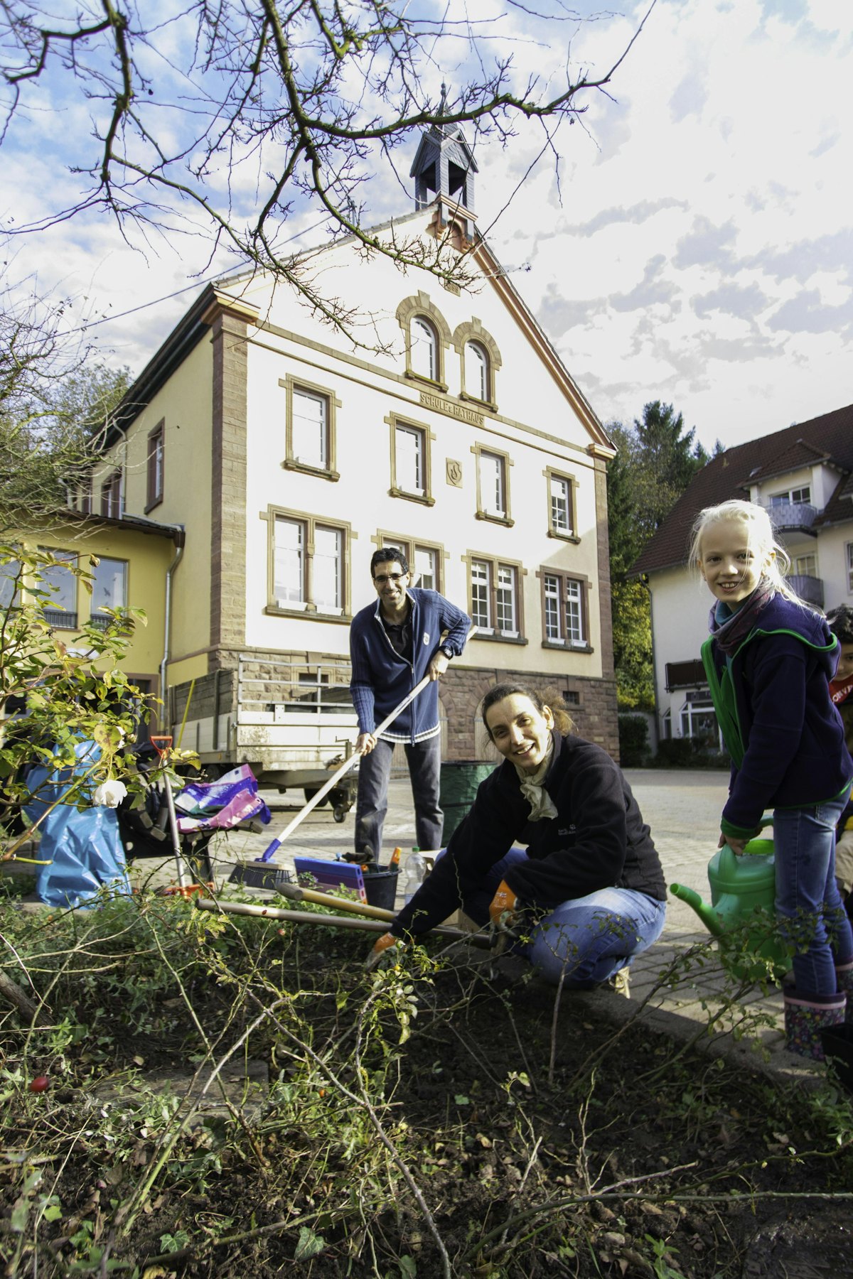 Families participated in a community-wide service project, weeding and planting flowers in a garden in the Gauangelloch town square.