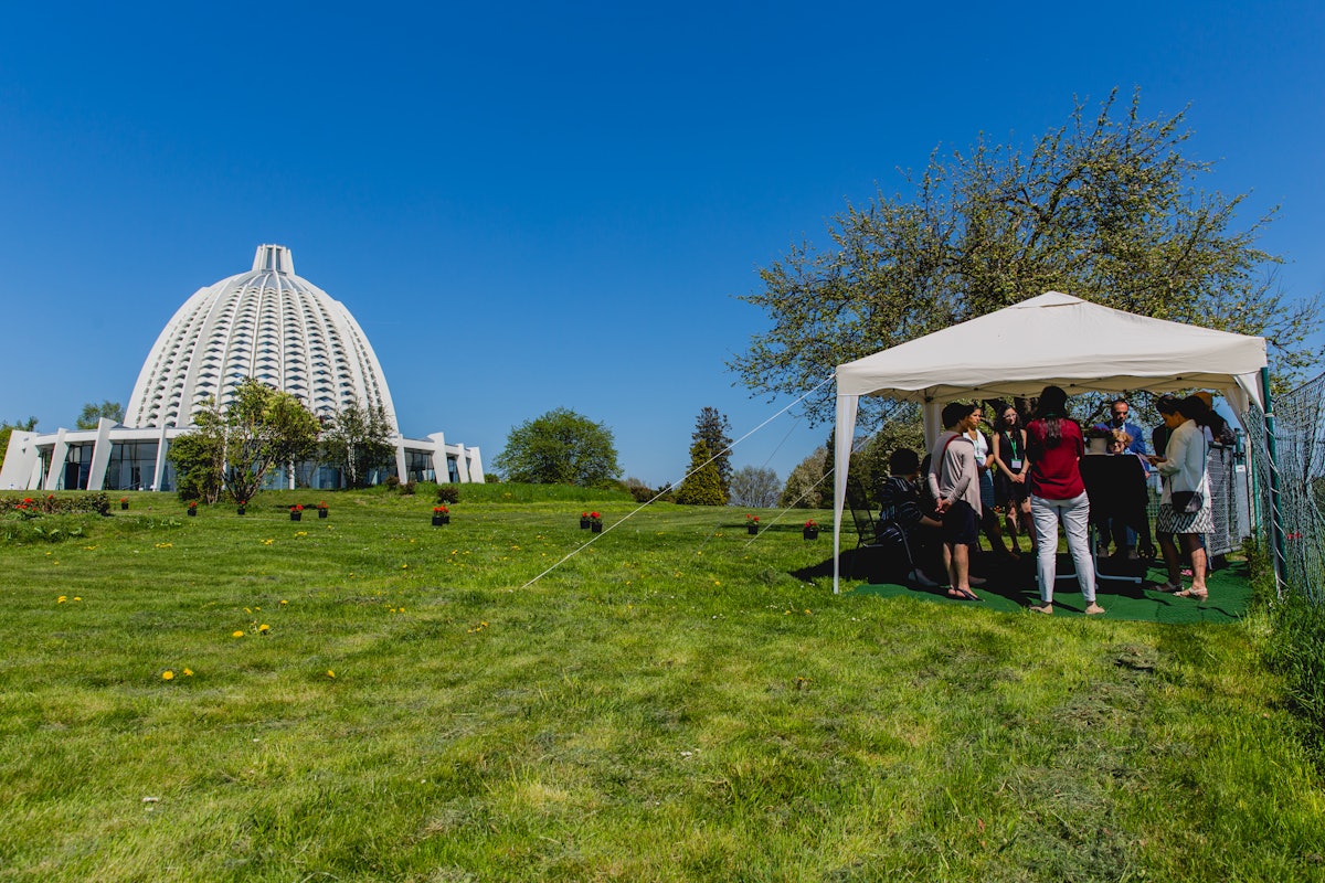 Attendees of the special exhibit, created to prepare for the upcoming bicentenary of the birth of the Bab, were guided on a geranium-lined path from the House of Worship to a nearby building, where the historic items were displayed.