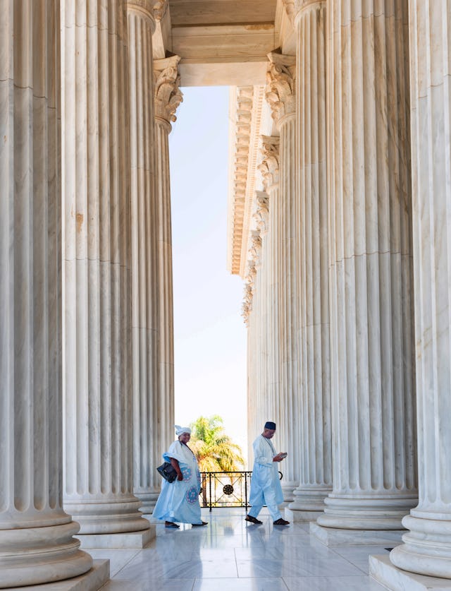 Two pilgrims enter the Seat of the Universal House of Justice.