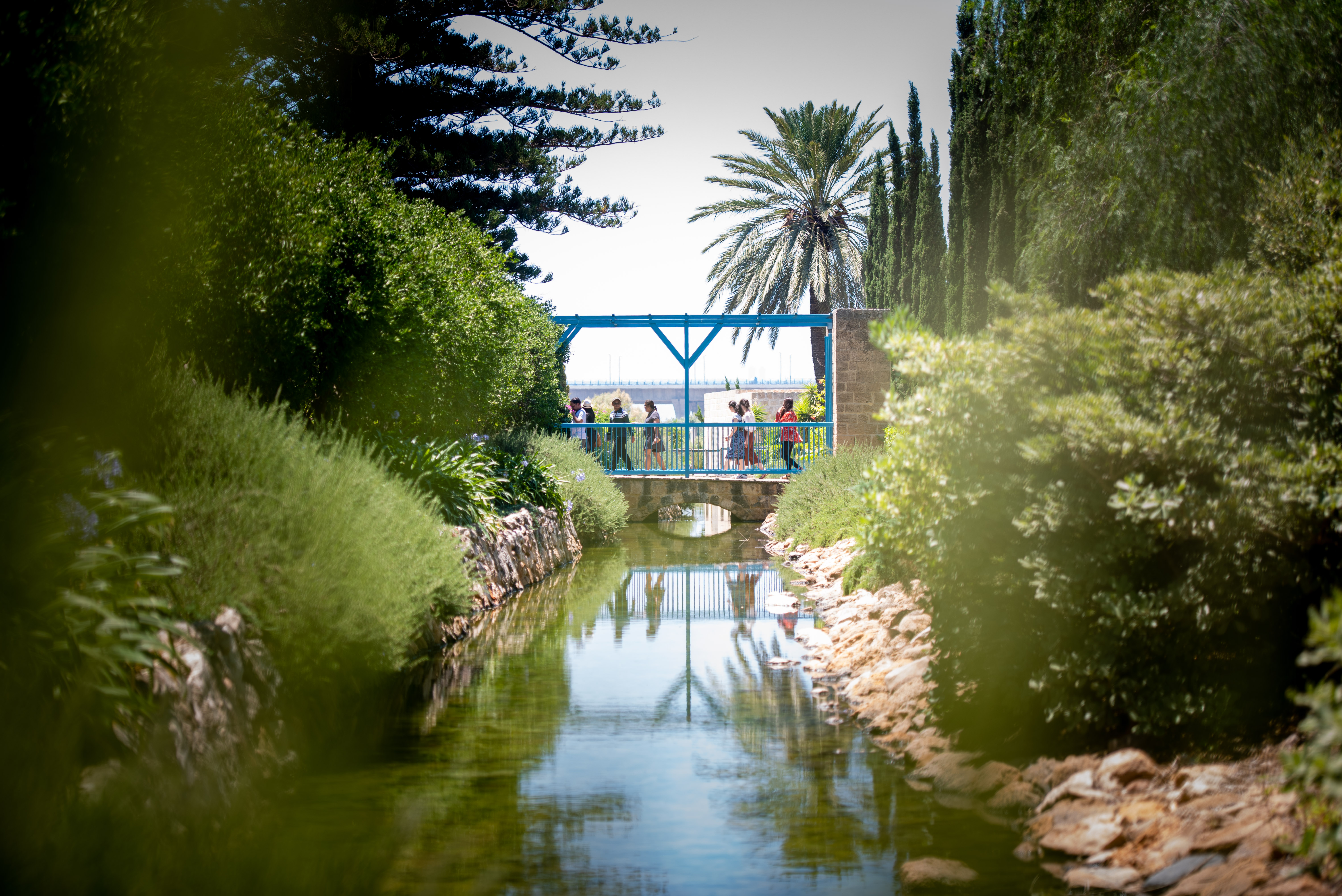 Pilgrims cross the bridge over a restored creek around the Ridvan Garden in Akka.