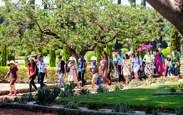 Pilgrims walk through the gardens in Bahji.