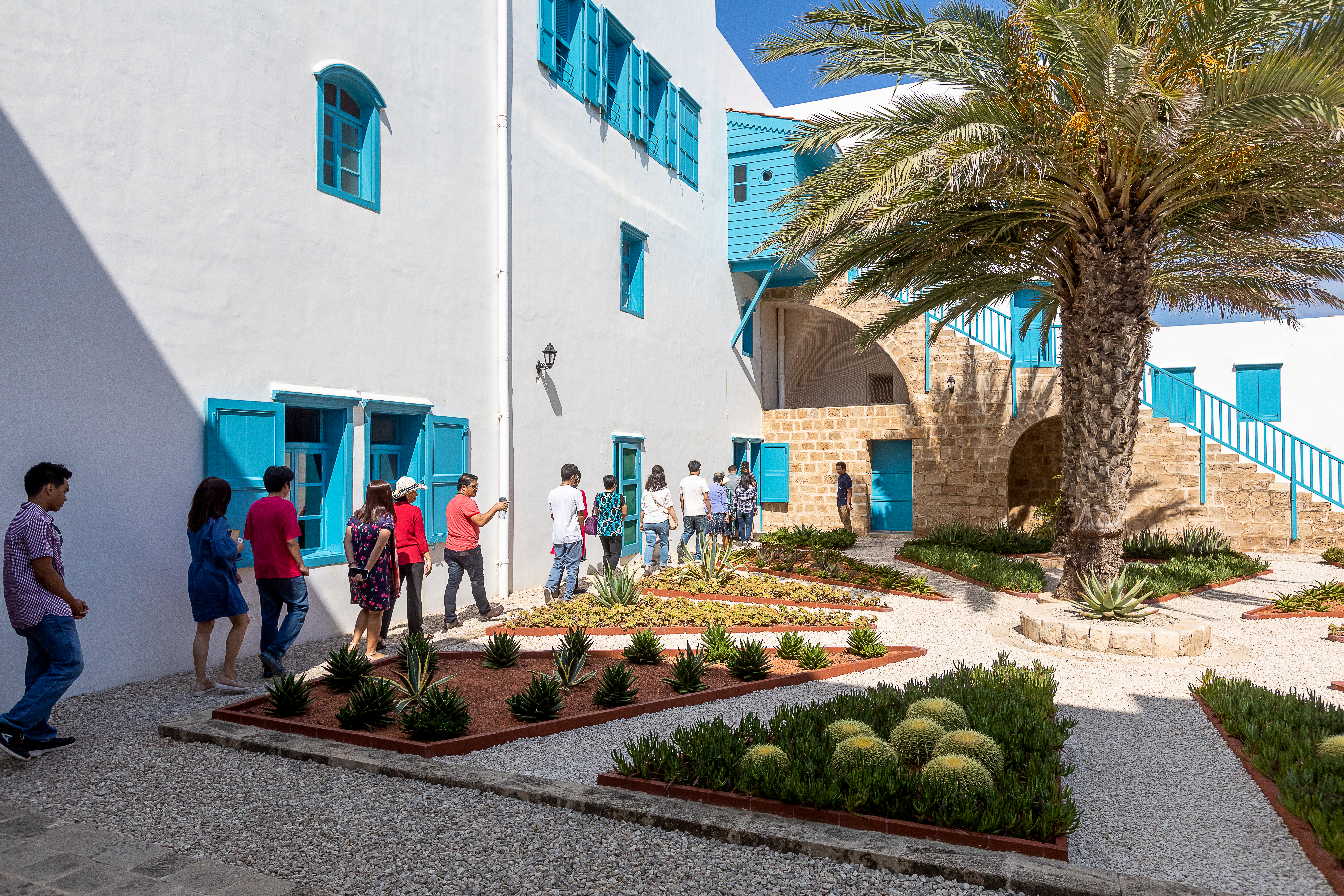 Pilgrims walk in the courtyard of the House of ‘Abdu’llah-Pasha in Akka.