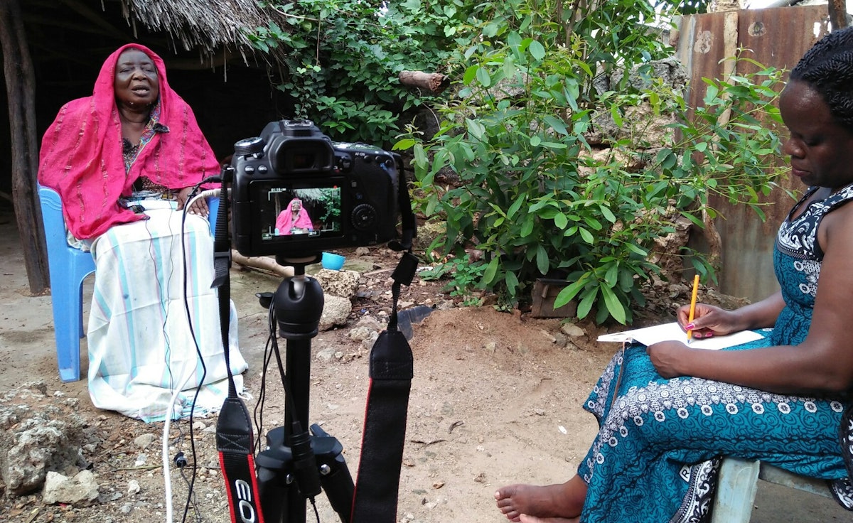 An interviewer listens as an elder Kenyan Baha’i shares about the history of the Faith in the country.