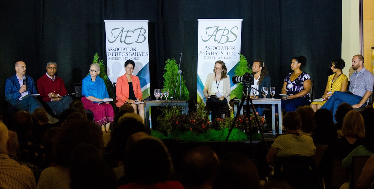 Michael Karlberg (left) speaks during a plenary session of the 43rd annual Association for Baha’i Studies Conference in Ottawa, Ontario, Canada. In the session, panelists explored constructive approaches in social movements. Dr. Karlberg was joined in the session by Michael Penn, Holly Hanson, Layli Maparyan, Caitlyn Bolton, Derik Smith, Elizabeth de Souza, Sahar Sattarzadeh, and Bradley Wilson. (Credit: Louis Brunet)