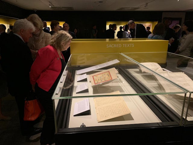 Visitors viewing original works of the Bab and Baha’u’llah on display at the opening evening of an exhibition in the British Library’s Treasure Gallery