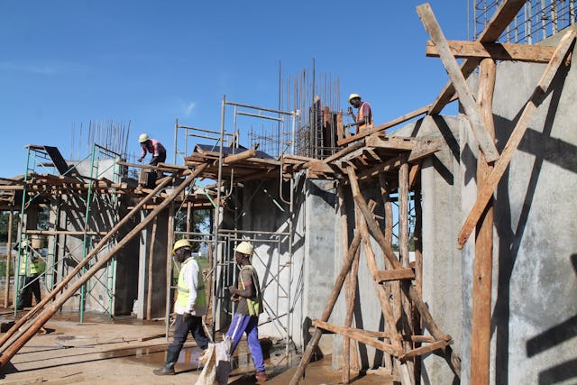 Workers build the Temple’s structural columns.