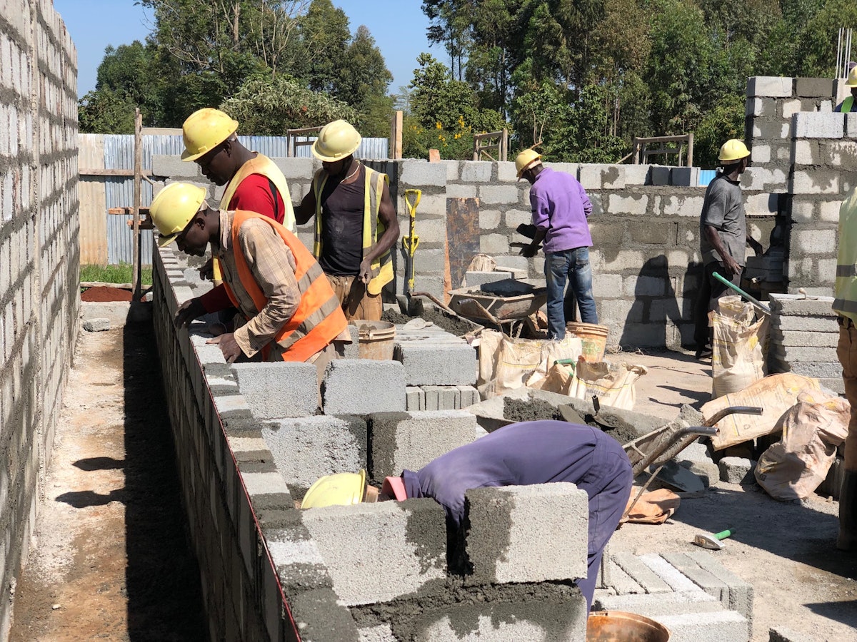 Construction workers lay bricks for one of the auxiliary buildings of the Kenya Temple.