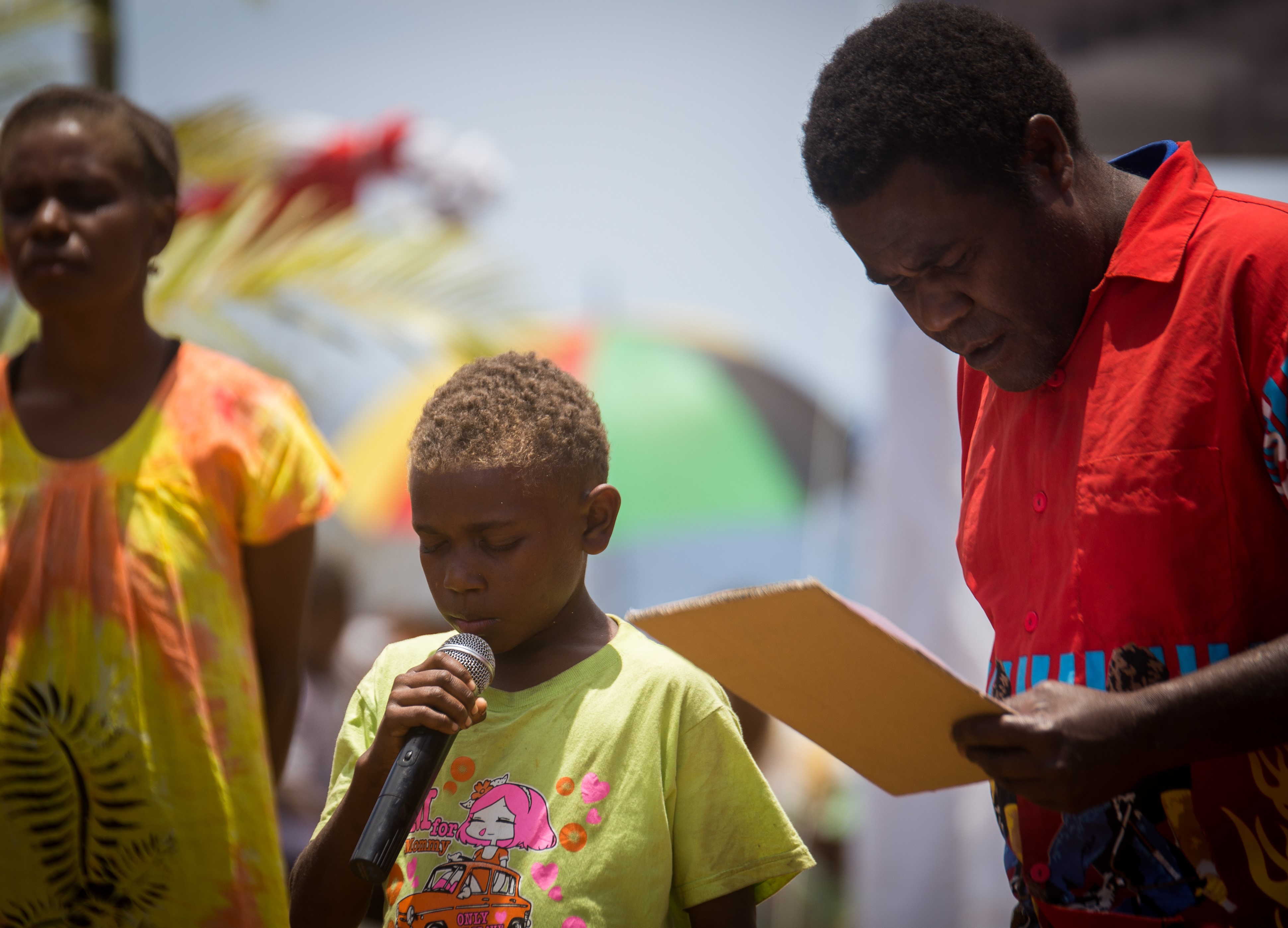 A child recites a prayer during the groundbreaking ceremony.