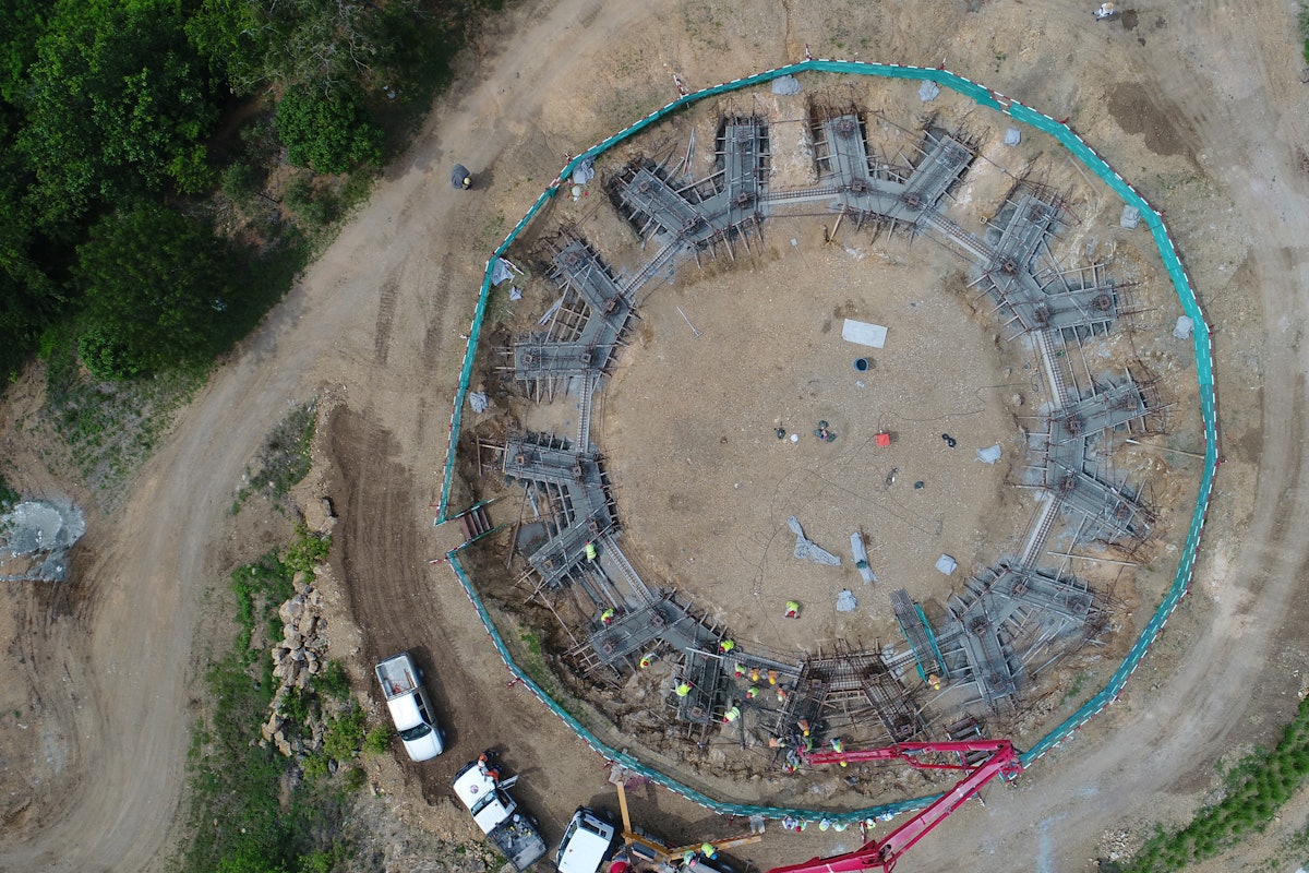 Construction crews complete the first concrete pour as work on the Temple’s foundation advances.